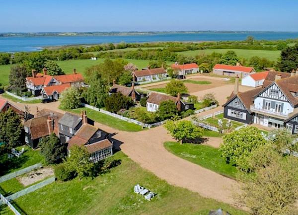 Aerial view of cottages on field-covered Ocea Island.