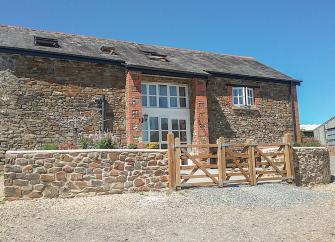 A stone-built Emoor farm barn conversion overlooks a courtyard.