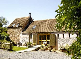 A barn conversion in Bicknoller overlooks a tree-fringed courtyard