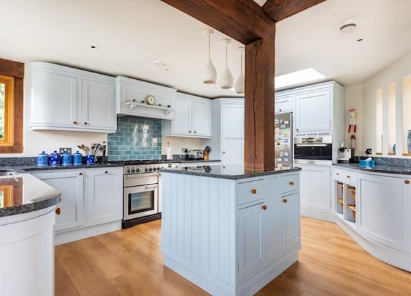 A fitted kitchen with integrated and worktop appliances.