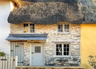 Exterior of a thatched holiday cottage in Thurlestone.