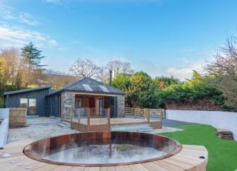  single-storey South Devon barn conversion overlooks a courtyard and a hot tub