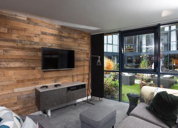 TV Room with widescreen TV and sofas.