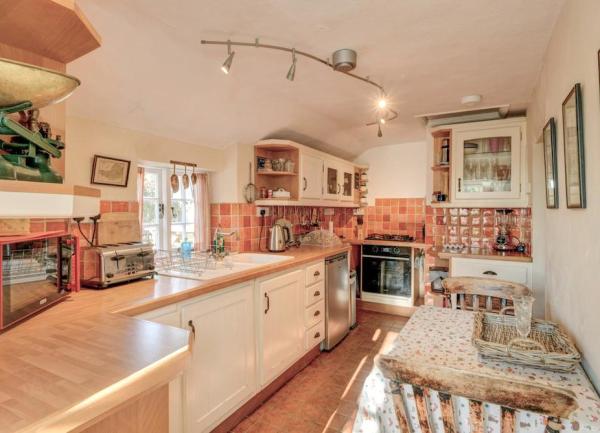 A galley-style kitchen with cupboards and a dining table for two.