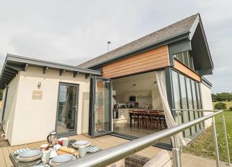 Contemporary wood and glass bungalow with floor to ceiling French windows