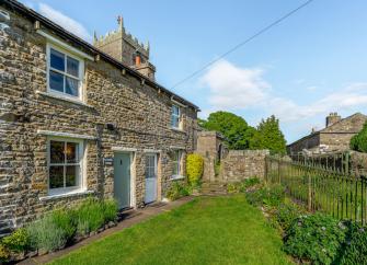 Terraced village cottages overlook a continuous front lawn.