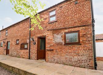 2-storey brick cottage overlooks a quiet street.