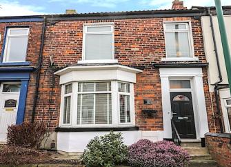 2-storey Victorian town house with bay windows and small front garden