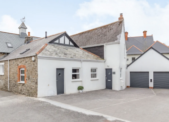 Exterior of a converted Devon coach house with a double garage