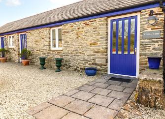 Exterior of a single-storey Cornish stone barn conversion.