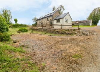 A Pembrokeshire stone barn conversion surrounded by fields.