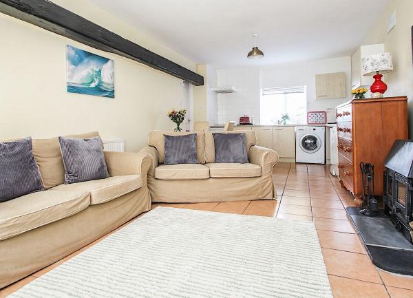 Open plan living area with a lounge and a fitted kitchen