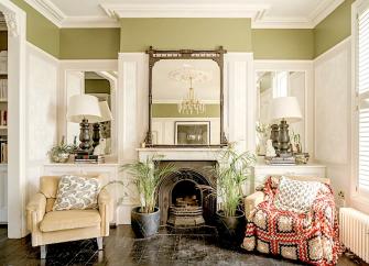 A lounge with a feature fireplace between two armchairs.