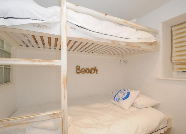 Bunk beds in a dual aspect bedroom.