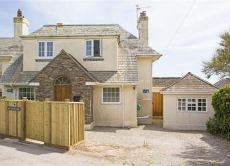 Front exterior of a 2-storey holiday home in Thurlestone with a wide drive for parking.