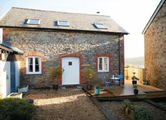 A stone-built barn conversion in North Devon overlooks a farm courtyard