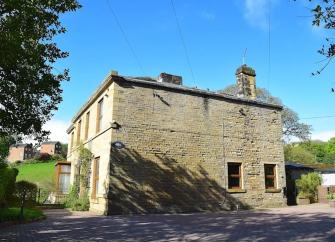 A large, 2 storey, stone-built holiday home in Holmfirth, overlooking a quiet lane