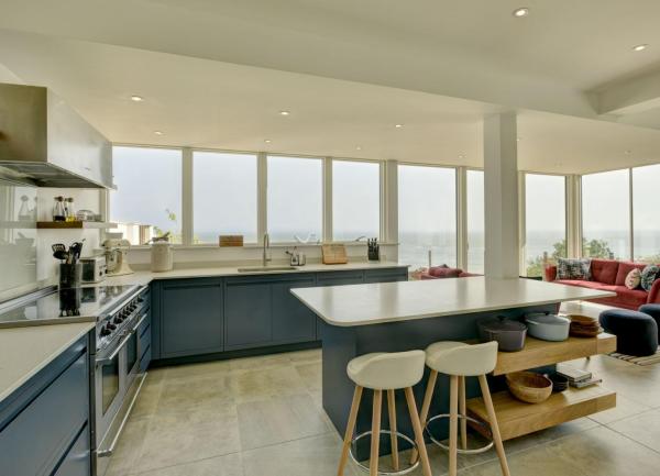 A fitted kitchen with integrated appliances and an island block.