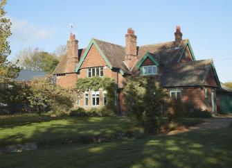 A large brick-built country house and gardens in Herefordshire.