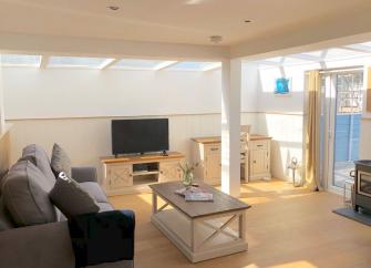 Interior of a spacious lounge with large roof lights in a Woolacombe holiday cottage.