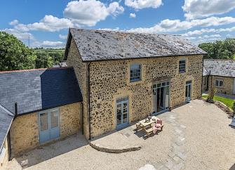 A stone, 2-storey, Dorset barn conversion overlooks a courtyard.