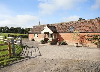 Single storey Somerset barn conversion overlooks a large courtyard.