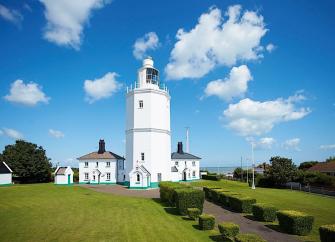 A clifftop lighthouse complex in Kent with well-kept lawns.