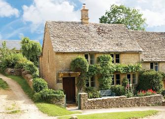 A jasmine-clad, semi-detached, traditional Cotswold 'honeystone' country cottage. 