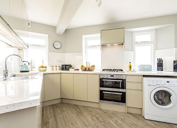 Fitted kitchen units incorporating an oven and washing machine.