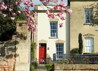 Exterior of a townhouse in Wells with a red front door.