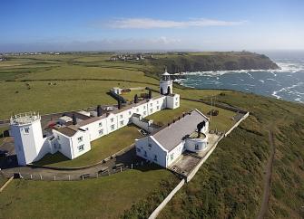 A lighthouse complex on a rugged clifftop in Cornwall.