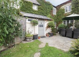 Exterior of a vine-covered Somerset farmhouse.