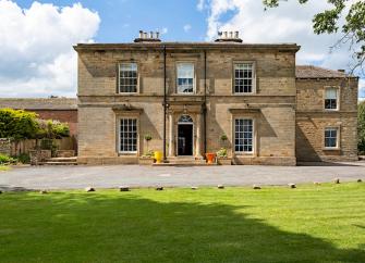 2-storey, stone-built, Georgian country house overlooking spacious lawns.