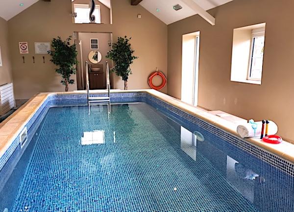An end-to-end view of an indoor swimming pool.