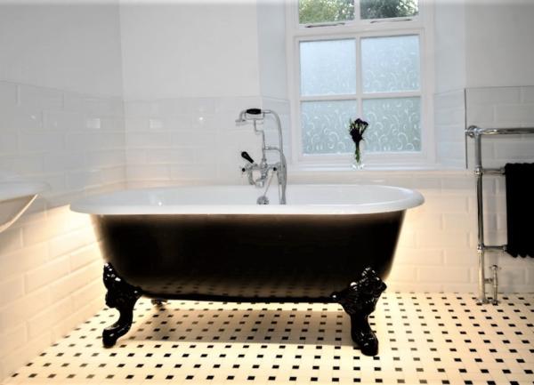 Tiled bathroom with stand alone bath.