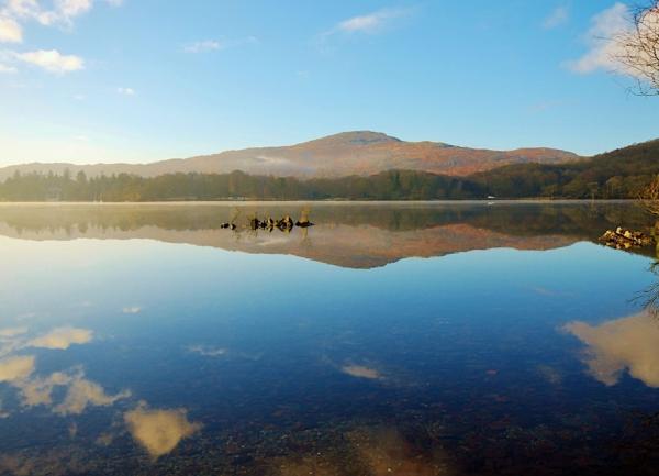 Mountains reflected in the calm surface of Coniston water 