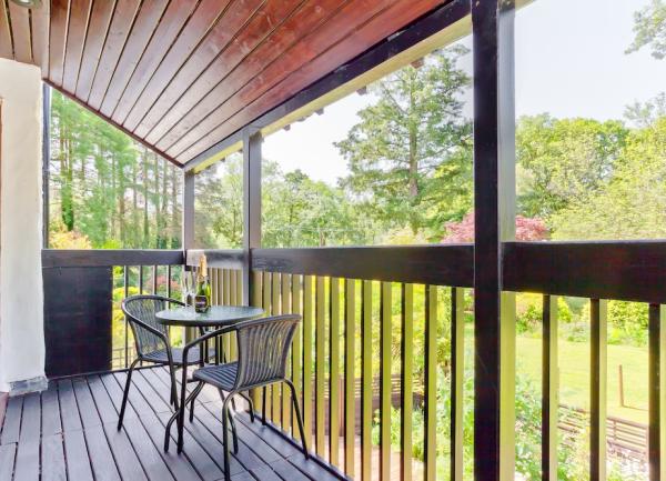 A covered 1st floor verandah with table and chairs.