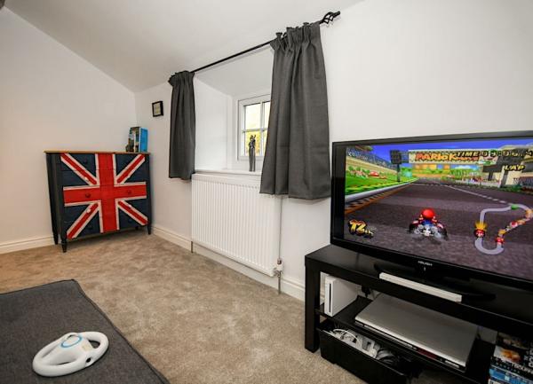 Games room with a large screen games console.