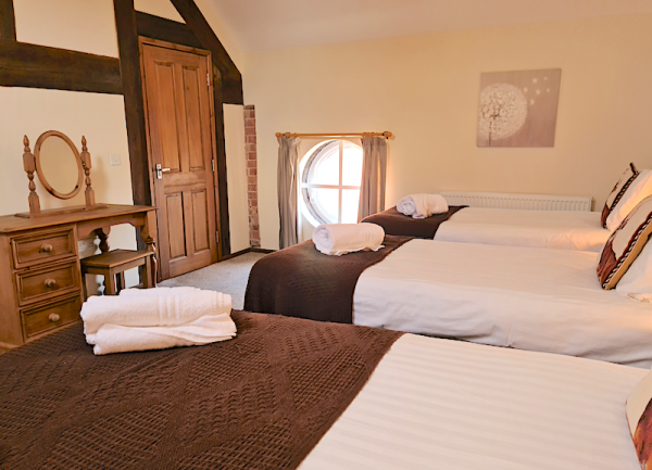 Three single bed and a dressing room form a triple bedroom in a Shropshire cottaghe