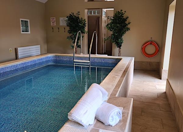 The indoor heated swimming pool in its own pool house.