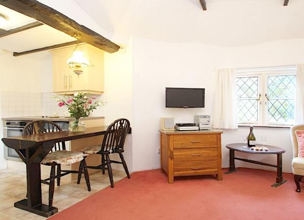 Dining area with a wooden table and spoonback wooden chairs.