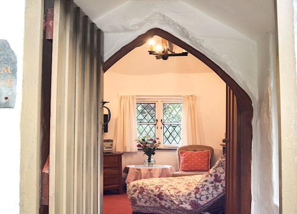 A view of the lounge through an arched door frame.