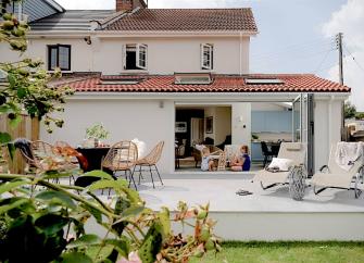 Exterior of a 2-storey contemporary home with twin floor-to-ceiling French windows opening onto the garden.