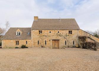 A large Cotswold barn conversion to form a holiday cottage in open countryside.