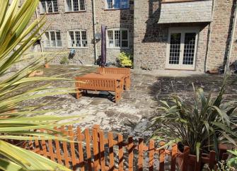 Stone-built exterior of an Exmoor country house and its courtyard garden.