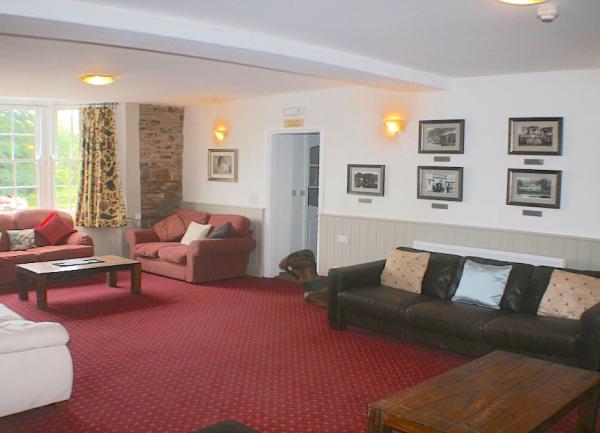 Lounge with bay window and four sofas.