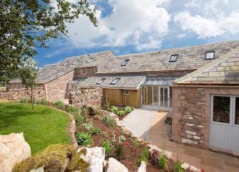 A rambling, stone-built cottage in Cumbria with a terraced garden