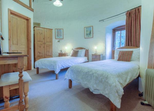 Twin bedroom with beds, wardrobe and dressing table.