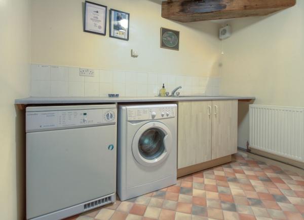 A separate. utility area withe washing machine, tumble dryer