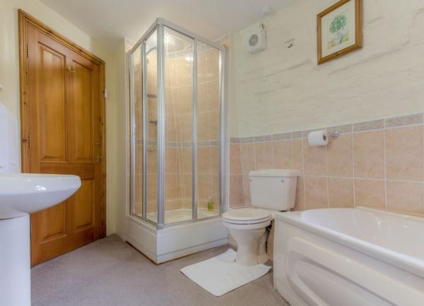Ensuite bathroom with shower, bath, washbasin and WC.